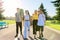 Outdoor, four teenagers walking together on road