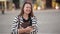 Outdoor funny lifestyle portrait of young pretty happy girl having fun on the street, laughing, positive, joy, travel