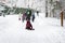 Outdoor games, winter leisure, several of unrecognizable little kids with teachers of kindergarten, walk holding hands