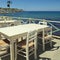 Outdoor greek cafe terrace overlooking the sea, Crete, Greece
