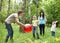 Outdoor happy family playing ball .