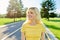 Outdoor headshot portrait of positive teenage blonde looking to the side