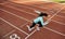 Outdoor horizontal image of young woman athlete running on racetrack at stadium. View from above of sportswoman during running