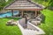 Outdoor kitchen sunken into ground by swimming pool to create a swim-up bar with concrete steps leading down