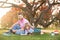 Outdoor learning. Father and son playing or studying with laptop in the park.