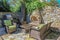 Outdoor living - rock wall and built-in outdoor fireplace built around a corner tree with wicker furniture and an electric outdoor