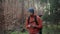 Outdoor mapping in hike. Man hiker uses smartphone to navigate in forest using an application and digital maps. Route