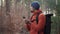 Outdoor mapping in hike. Man hiker uses smartphone to navigate in forest using an application and digital maps. Route
