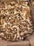 outdoor market bench; box on display with sackcloth full of dried porcini mushrooms. Selection of the fungus called chestnut head