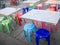 Outdoor metal table and colored plastic chair, street food scene in Thailand