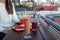 An outdoor patio bar top with a fruit platter, and glass drinks with food-grade, silicone straws