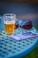 Outdoor patio table with mobile phone sunglasses and beer flight glass