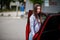 Outdoor photo of gorgeous woman posing near orange suv car