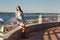 Outdoor photo of a romantic European woman with long hair spending time outdoors exploring a European city