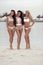 Outdoor photo of three sexy bikini girls models in fashion swimsuits on tropical beach at Maldives island. Slim ladies with tan