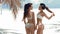 Outdoor photo of two sexy bikini girls models in fashion swimsuits on tropical beach at Maldives island. Slim ladies with ten