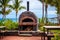 an outdoor pizza oven at a beachside resort