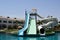 Outdoor pool with blue clear warm water and water slides pipes on vacation in a tropical warm exotic country, a seaside resort wit