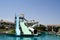 Outdoor pool with blue clear warm water and water slides pipes on vacation in a tropical warm exotic country, a seaside resort wit