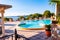 Outdoor pool with vibrant crystal water, parasols and deck chairs located on the coast of Garda lake in amazing La Ca camping in