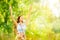 Outdoor Portrait of Beautiful Young Woman in Nature. Happy Girl Raised Arms Up in Summer Park