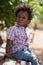 Outdoor portrait of a black baby sited on a bench