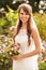 Outdoor Portrait Of Bride Holding Bouquet On Wedding Day