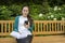 Outdoor portrait of a college student with a phone and a book