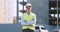 Outdoor portrait of confident builder standing with folded hands at construction site