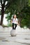 Outdoor portrait of a cute Malaysian little girl with long hair jumping from the concrete ball in the park