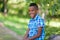 Outdoor portrait of a cute teenage black boy - African people