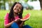 Outdoor portrait of a cute young black little girl eating watermelon - African people