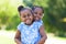 Outdoor portrait of a cute young black sisters - African people