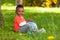 Outdoor portrait of a cute young little black boy playing with