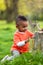 Outdoor portrait of a cute young little black boy playing outsi