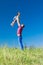 Outdoor portrait of a father who throws daughter on hands against the sky