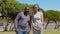 Outdoor portrait of a happy man and woman. A black guy and a white girl are smiling. Black and white couple in love.