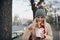 Outdoor portrait of happy pretty woman eating asian wok fast food from takeaway white paper box at the city street. Student female