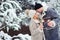 Outdoor portrait of happy romantic couple celebrating Christmas with burning fireworks