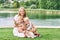 Outdoor portrait of happy young mother with two lovely children