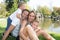 Outdoor portrait play near river lake outdoor park happy family Mother father and children son