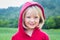 Outdoor portrait portait of cute child in a red hoodie