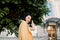 Outdoor portrait of pretty young mixed raced white girl in yellow blazer, posing to camera and enjoying her city walk