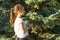 Outdoor portrait in profile of a beautiful smiling girl 7 years. Copy space, background green tree