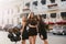 Outdoor portrait of slim girls having fun together after party and walking down the street. Stunning young female models