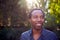 Outdoor Portrait Of Smiling African American Man At Home Relaxing At Garden Party