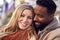 Outdoor Portrait Of Smiling Loving Couple Wearing Coats And Scarves In Autumn Or Fall