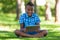 Outdoor portrait of student black boy using a tactile tablet