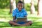 Outdoor portrait of student black boy using a tactile tablet