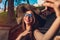 Outdoor portrait of stylish woman wearing classic glasses and hat. Beautiful model in vintage clothing and accessories